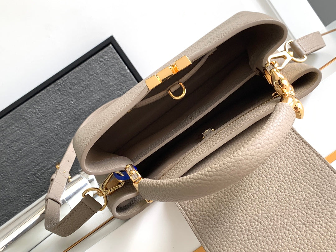 CAPUCINES BB 27 IN KHAKI BRAUN TAURILLON GOLD HARDWARE