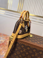 LV 25S NANO ALMA 18 IN BROWN MONOGRAM CANVAS PRINTED WITH THE VIVIENNE MASCOT