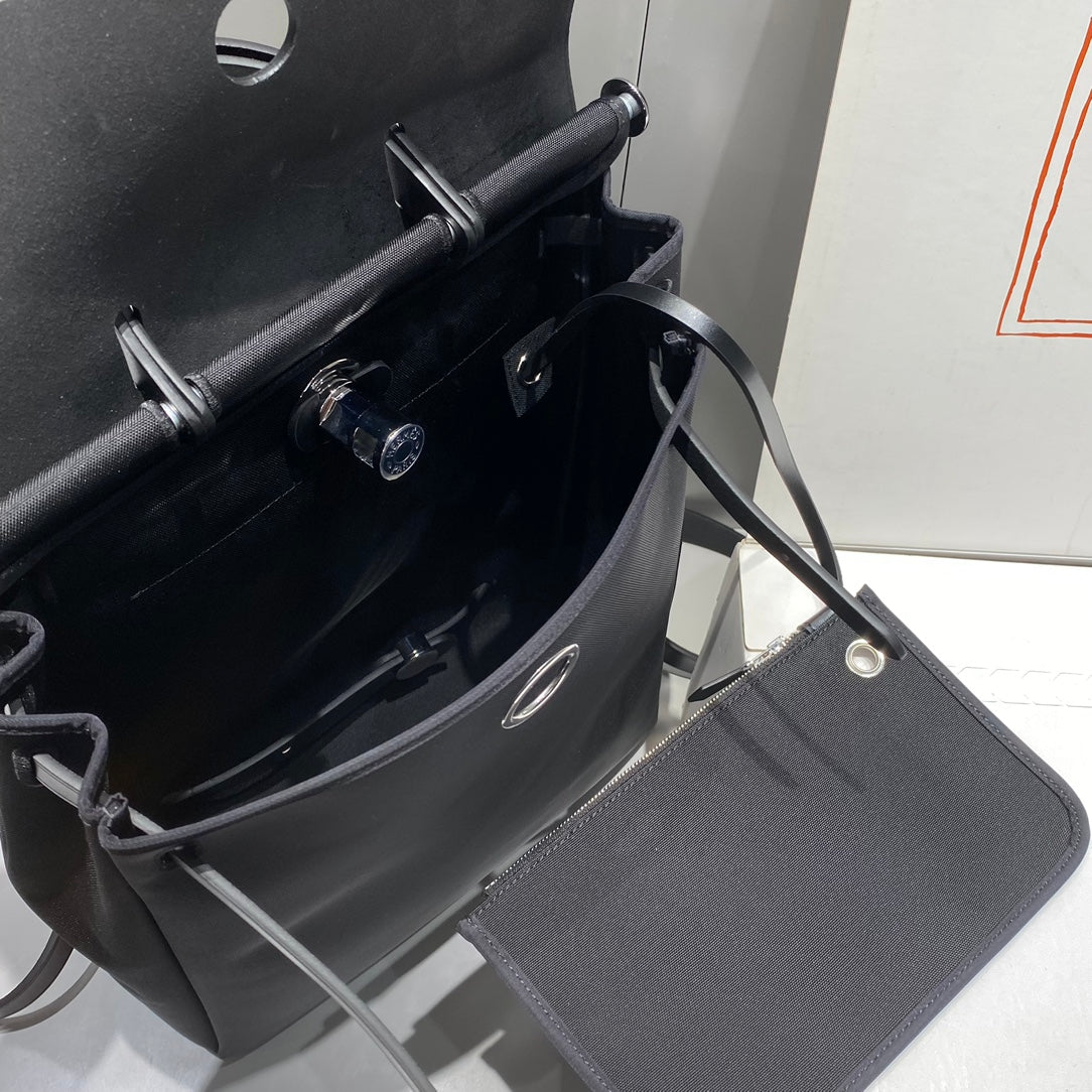 HERBAG A DOS ZIP RETOURNE BACKPACK 29 IN BLACK CANVAS AND CALFSKIN