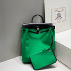 HERBAG A DOS ZIP RETOURNE BACKPACK 29 IN GREEN CANVAS AND BLACK CALFSKIN