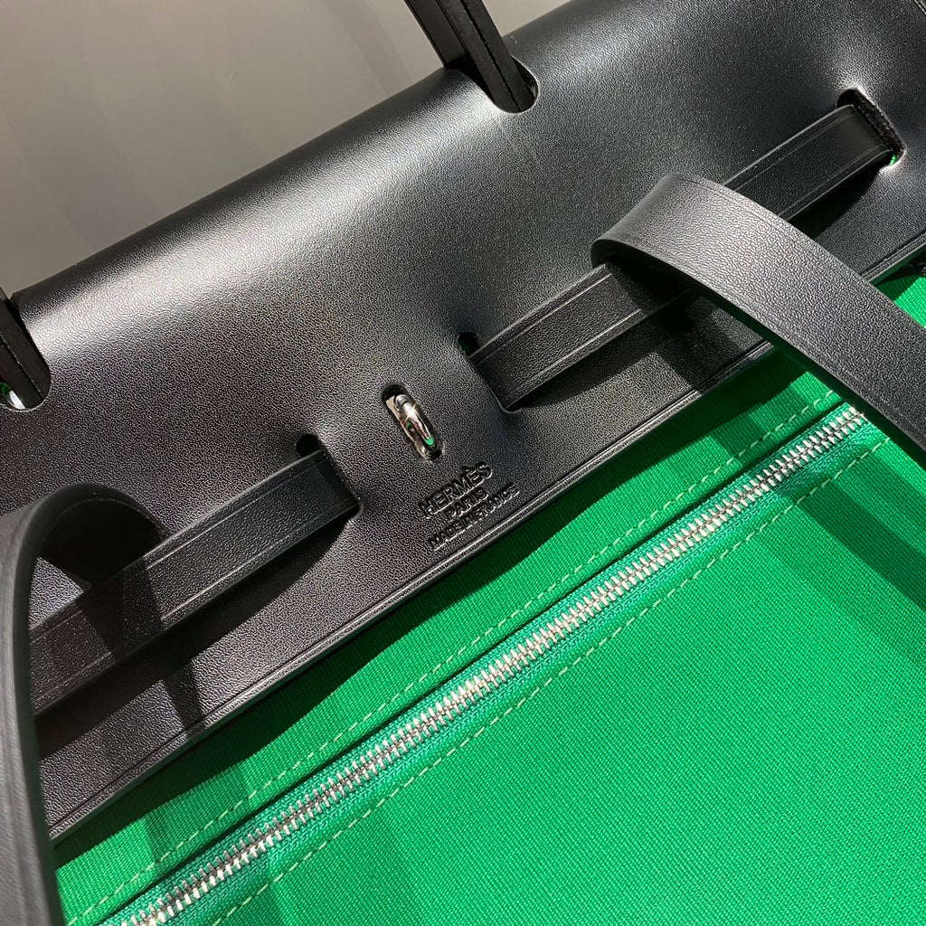 HERBAG A DOS ZIP RETOURNE BACKPACK 29 IN GREEN CANVAS AND BLACK CALFSKIN