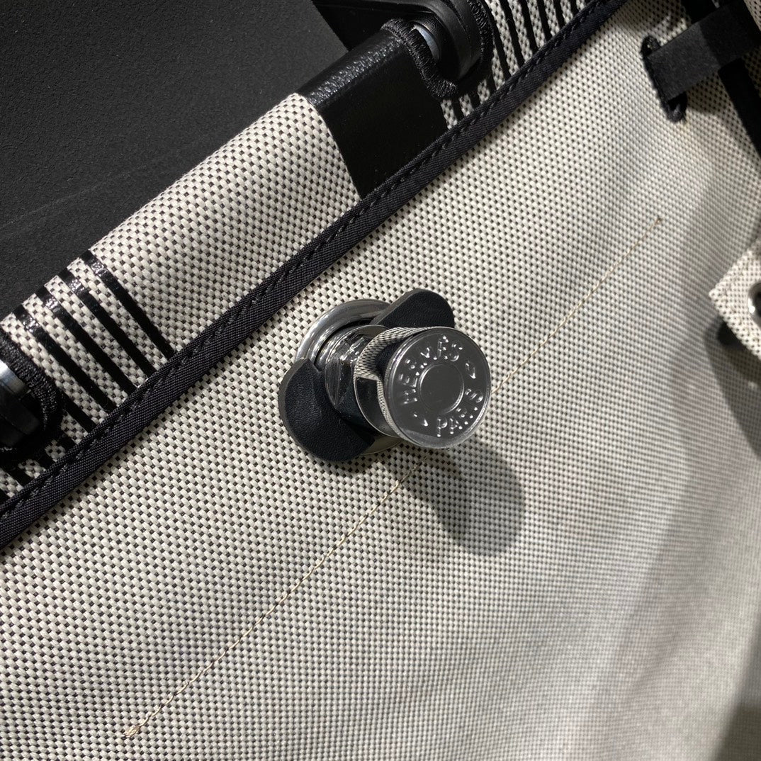 HERBAG A DOS ZIP RETOURNE BACKPACK 29 IN OFF-WHITE MIX BLACK CANVAS AND CALFSKIN