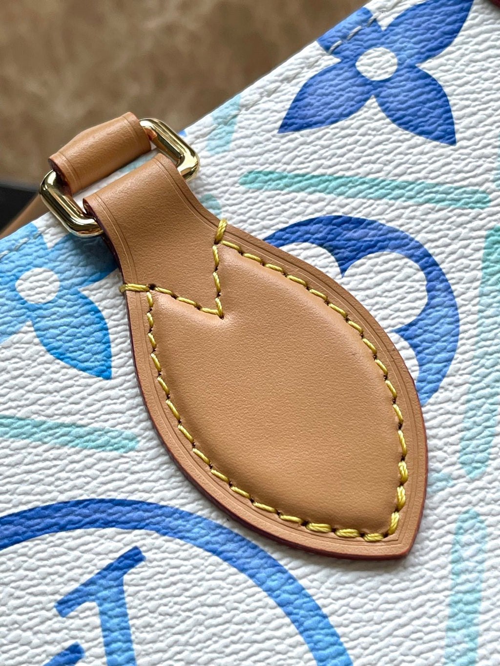 ONTHEGO EAST WEST 25 IN LAGOON BLUE MONOGRAM TILES CANVAS