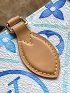 ONTHEGO EAST WEST 25 IN LAGOON BLUE MONOGRAM TILES CANVAS