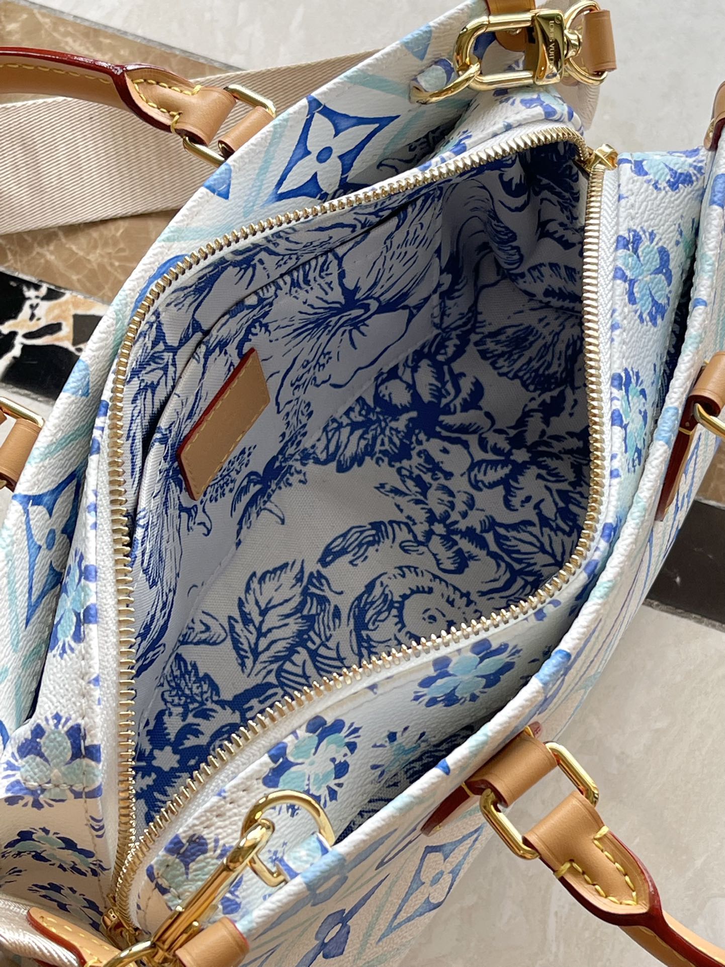 ONTHEGO EAST WEST 25 IN LAGOON BLUE MONOGRAM TILES CANVAS