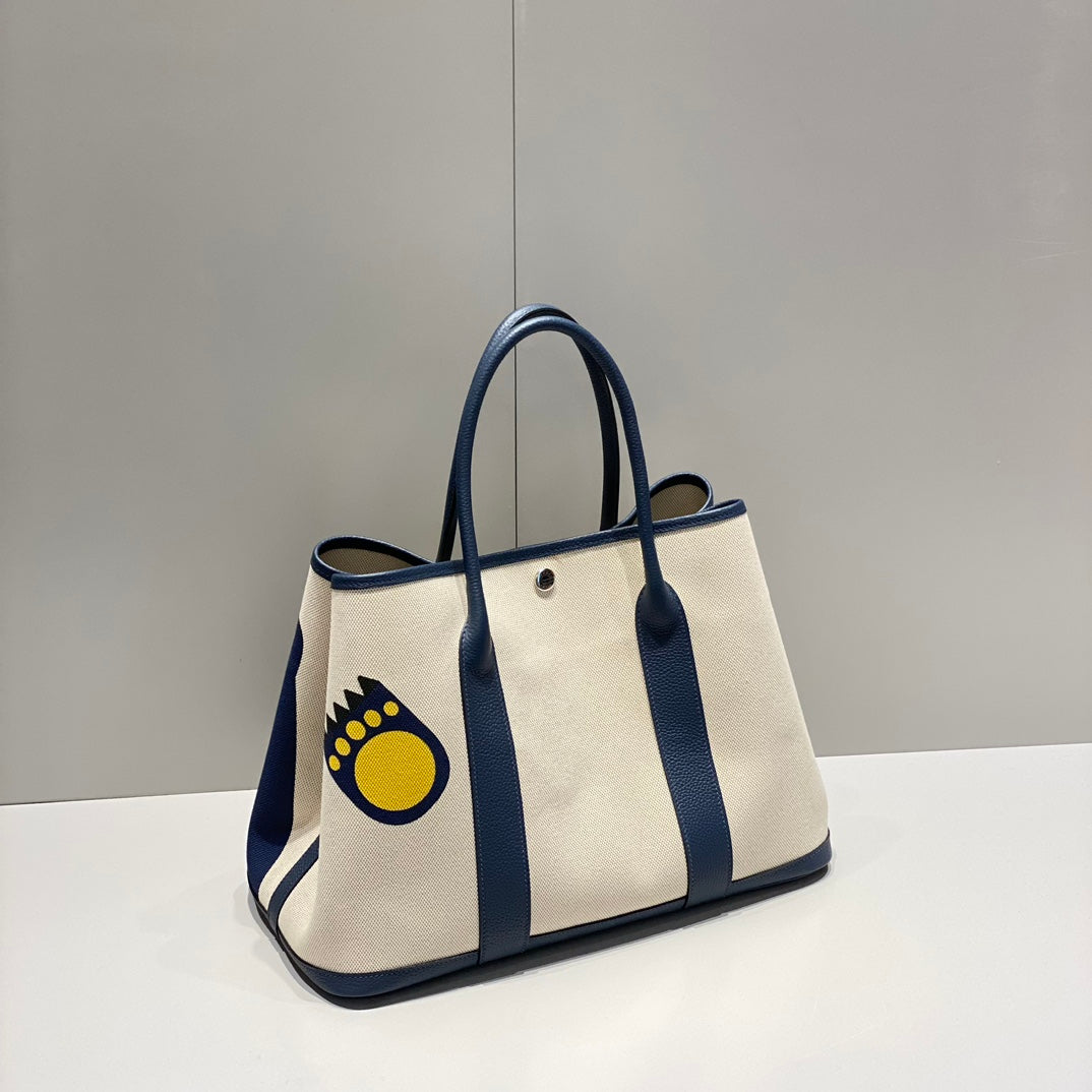 GARDEN PARTY 36 IN NAVY CREAM TOILE H CANVAS BLUE MARINE CALFSKIN ABSTRACT BEAR FACE PRINT