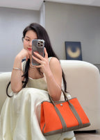 GARDEN PARTY 30CM IN ORANGE MINIMUM TOILETS COTTON CANVAS AND BROWN CALFSKIN