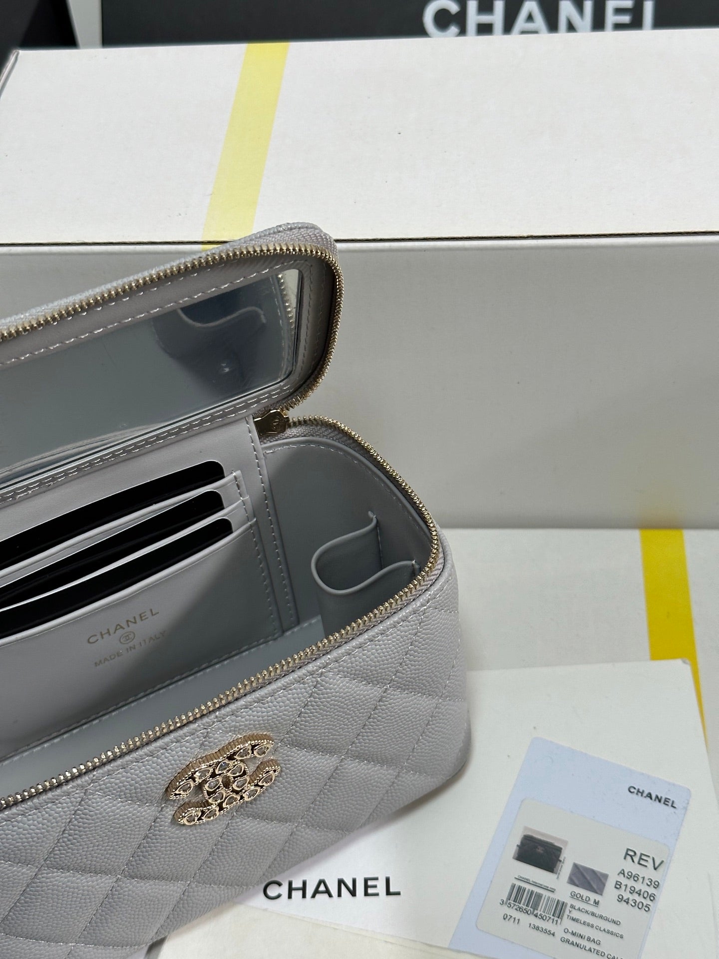 Kosmetikkoffer mit 17 Kristallbesetztem Logo in grauem Kalbsleder und goldenen Beschlägen